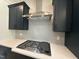 Close-up of the kitchen's gas cooktop and herringbone backsplash at 73 Sage Ln # 008, Four Oaks, NC 27524