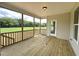 Spacious screened porch with wooden deck overlooking a large yard at 73 Sage Ln # 008, Four Oaks, NC 27524