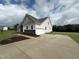 Two-story home with side view showcasing garage and landscaping at 73 Sage Ln # 008, Four Oaks, NC 27524