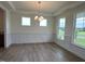 Formal dining room with hardwood floors, wainscoting and large windows at 123 Sage Ln # 10, Four Oaks, NC 27524