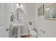 Stylish powder room with pedestal sink and toilet at 305 Sutherland Dr, Franklinton, NC 27525