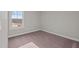 Spacious bedroom with carpeted floor and large window at 305 Sutherland Dr, Franklinton, NC 27525