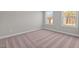 Bright bedroom featuring neutral walls and carpeted floors at 305 Sutherland Dr, Franklinton, NC 27525