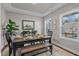 Elegant dining room featuring a large table, bench, and natural light at 305 Sutherland Dr, Franklinton, NC 27525