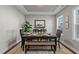 Well-lit dining room with a wooden table and bench seating at 305 Sutherland Dr, Franklinton, NC 27525