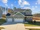 Two-story craftsman style home with gray siding and a two-car garage at 305 Sutherland Dr, Franklinton, NC 27525