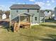 Two-story house with deck and stairs, surrounded by a grassy yard at 305 Sutherland Dr, Franklinton, NC 27525