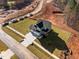New construction home aerial view, showcasing the house and surrounding undeveloped land at 345 Sutherland Dr, Franklinton, NC 27525