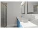 Modern bathroom with dual vanity, white countertops, and blue cabinets at 345 Sutherland Dr, Franklinton, NC 27525