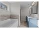 Elegant bathroom featuring a soaking tub, dual vanity, and tile flooring at 345 Sutherland Dr, Franklinton, NC 27525