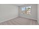 Simple bedroom with neutral wall and carpet, featuring a large window at 345 Sutherland Dr, Franklinton, NC 27525