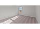 Spacious bedroom with carpeted floor and a window overlooking the backyard at 345 Sutherland Dr, Franklinton, NC 27525