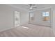 Spacious bedroom with plush carpeting, ceiling fan, and ensuite bathroom access at 345 Sutherland Dr, Franklinton, NC 27525