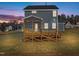 Two-story house with gray siding, a deck, and a well-maintained lawn at 345 Sutherland Dr, Franklinton, NC 27525
