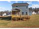 Two-story house with gray siding, a deck, and a well-maintained lawn at 345 Sutherland Dr, Franklinton, NC 27525