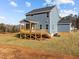 Two-story house with gray siding, a deck, and a well-maintained lawn at 345 Sutherland Dr, Franklinton, NC 27525