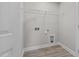 Functional laundry room with overhead shelving and space for washer and dryer at 345 Sutherland Dr, Franklinton, NC 27525