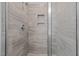 Clean shower with gray tile and frameless glass enclosure at 345 Sutherland Dr, Franklinton, NC 27525