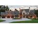 Luxury home exterior with a three car garage and circular driveway at 102 Peddler Mill Way, Pittsboro, NC 27312