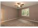 Well-lit bedroom with neutral walls, plush carpet and ceiling fan at 809 E Edgerton St, Dunn, NC 28334