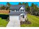 Two-story house with gray siding, white garage door, and landscaped yard at 141 Beacon Hill Rd # 13, Lillington, NC 27546