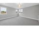 Bright bedroom with carpet flooring and multiple windows at 2635 Marchmont St, Raleigh, NC 27608