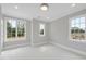 Light-filled bedroom with large windows and neutral decor at 2635 Marchmont St, Raleigh, NC 27608