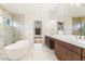 Spa-like bathroom with soaking tub, double vanity, and marble floors at 43 Laurel Knoll Dr, Pittsboro, NC 27312