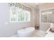 Relaxing bathroom with soaking tub and walk-in shower at 6829 Sleeping Meadow Ln, Holly Springs, NC 27540