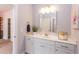 Bathroom with white vanity, mirror, and a lovely plant at 6829 Sleeping Meadow Ln, Holly Springs, NC 27540