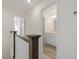 Upstairs hallway with dark wood railings and access to bathroom at 17 Shelby Meadow Ln, Angier, NC 27501