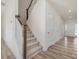 Modern staircase with simple wood railing and beige carpet at 17 Shelby Meadow Ln, Angier, NC 27501
