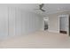 Spacious bedroom with access to bathroom, ceiling fan, and neutral color palette at 125 Cotton Fields Ln # 26, Fuquay Varina, NC 27526