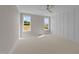 Bright bedroom with wall paneling, carpet, and large windows offering natural light at 125 Cotton Fields Ln # 26, Fuquay Varina, NC 27526