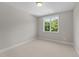 Simple bedroom with carpeted floor, neutral walls, and a large window at 125 Cotton Fields Ln # 26, Fuquay Varina, NC 27526