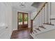 Two-story entryway with hardwood floors and wooden staircase at 125 Cotton Fields Ln # 26, Fuquay Varina, NC 27526