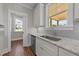 Kitchen features white cabinets, granite countertops, and a stainless steel sink at 125 Cotton Fields Ln # 26, Fuquay Varina, NC 27526