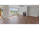 Bright living room with fireplace, built-in shelving, and hardwood floors at 125 Cotton Fields Ln # 26, Fuquay Varina, NC 27526