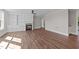 Spacious living area with hardwood floors and a stone fireplace at 125 Cotton Fields Ln # 26, Fuquay Varina, NC 27526