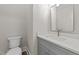 Modern powder room with gray vanity and quartz countertop at 125 Cotton Fields Ln # 26, Fuquay Varina, NC 27526