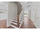 Elegant wooden staircase with white railings leading to the upper level at 125 Cotton Fields Ln # 26, Fuquay Varina, NC 27526