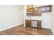 Small galley kitchen with wood cabinets, stainless steel appliances, and hardwood floors at 901 Wildflower Ridge Rd, Wake Forest, NC 27587