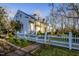 White farmhouse with a picket fence and brick walkway at 6720 Mebane Oaks Rd, Mebane, NC 27302