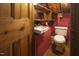 Small bathroom with toilet and sink, showing rustic wooden details at 6720 Mebane Oaks Rd, Mebane, NC 27302