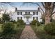 White farmhouse with brick pathway and landscaping at 6720 Mebane Oaks Rd, Mebane, NC 27302