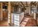 Large kitchen with island, exposed beams, and brick flooring at 6720 Mebane Oaks Rd, Mebane, NC 27302