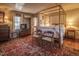 Charming bedroom featuring a four-poster bed and ornate rug at 6720 Mebane Oaks Rd, Mebane, NC 27302
