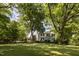 White farmhouse with lush green landscape at 6720 Mebane Oaks Rd, Mebane, NC 27302