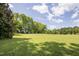 Charming two-story home with large grassy yard and mature trees at 6720 Mebane Oaks Rd, Mebane, NC 27302