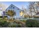 White farmhouse with an American flag and beautiful landscaping at 6720 Mebane Oaks Rd, Mebane, NC 27302